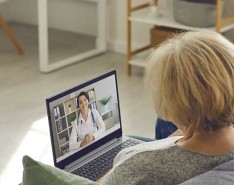 senior couple chatting with doctor on computer