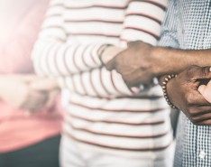 people of different races holding hands