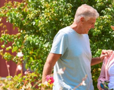 a senior couple enjoys time in a garden