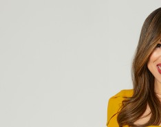 Lalaina Rabary smiling in front of a gray backdrop