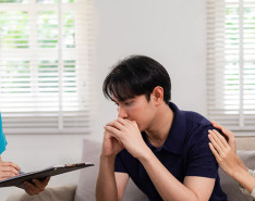 A caregiver talking with a young couple