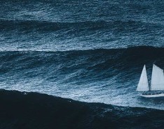 A sailboat out on choppy waves