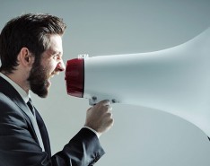 man yelling into megaphone