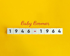 Yellow background that says "Baby Boomer" in red cursive and "1946-1964" in block numbers