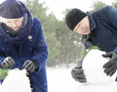 seniors building a snowman