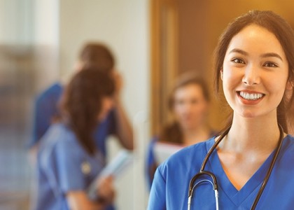 A nurse smiles at the camera