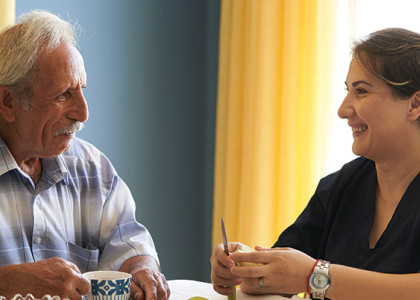 An older male patient talking with his home health provider