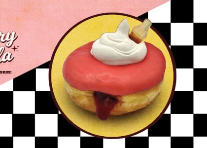 A cherry cola flavored donut on top of a blackened white checkered background