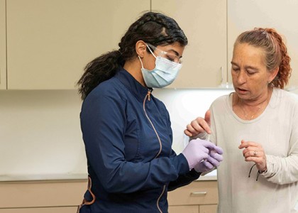 A dentist is working with a patient and his caregiver