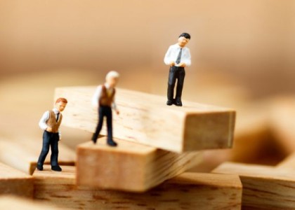 Toy business men on building blocks