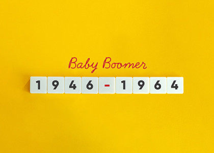 Yellow background that says "Baby Boomer" in red cursive and "1946-1964" in block numbers