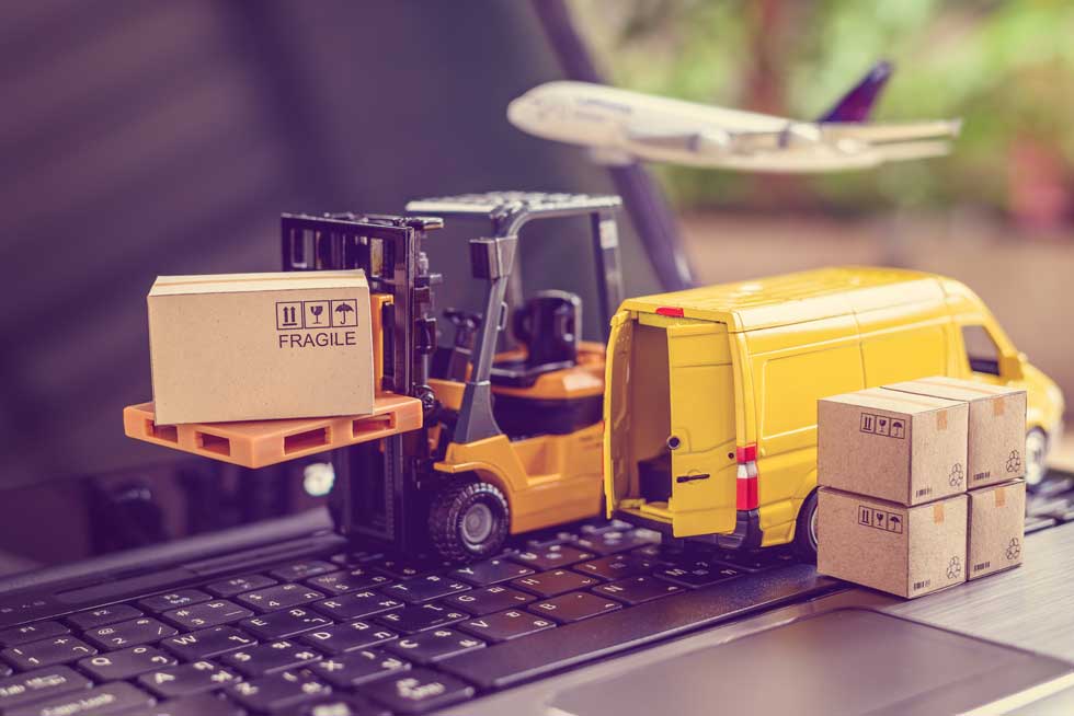 toy forklift and van on keyboard to illustrate supply chain