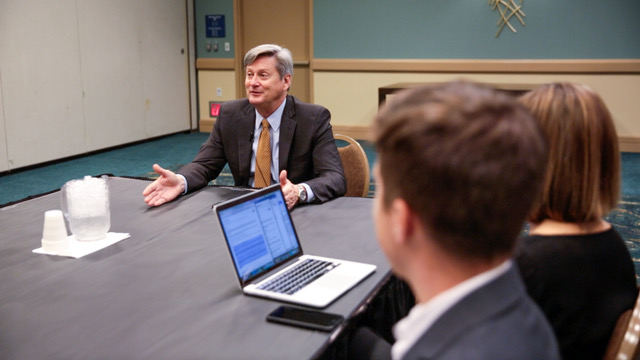 older white male around conference table Bill Dombi